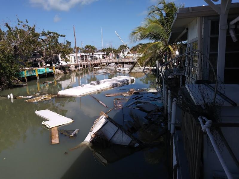 An RV sunk in one of the neighborhood canals is just a small part of the debris common in the Keys.  Canal cleanup began in June 2018 and continues still.